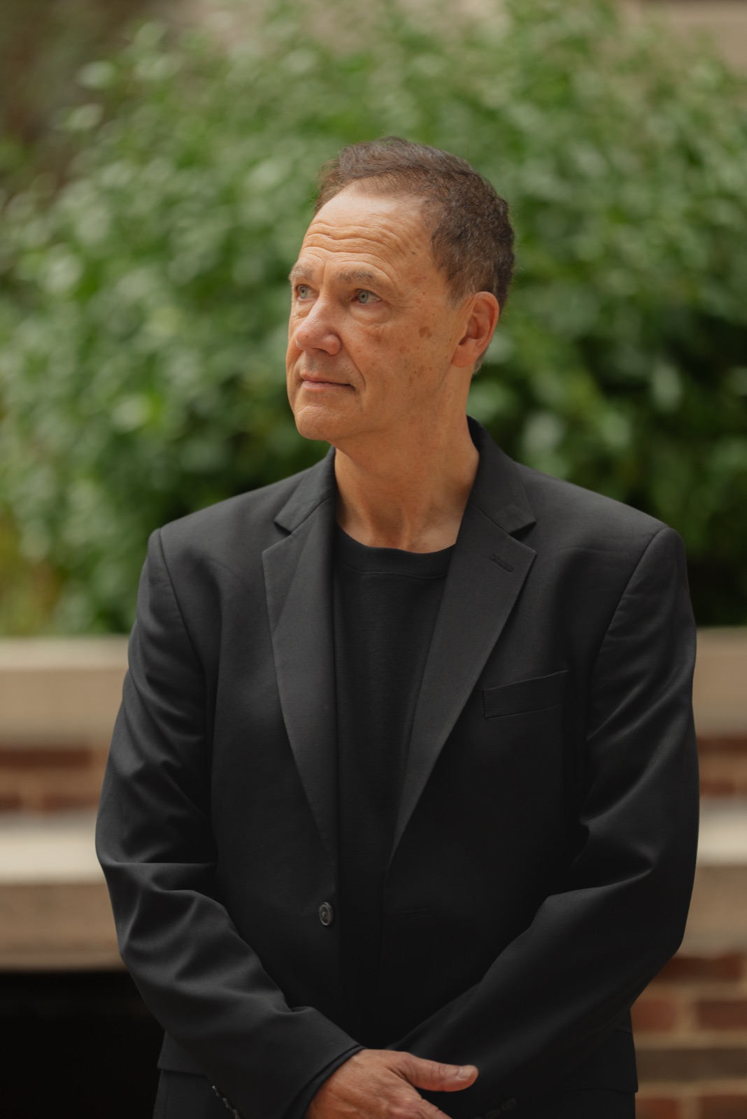 Chuck Garcia, contemplative outdoor portrait, looking into the distance.